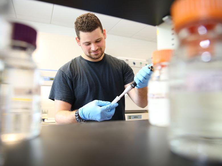 Male student working in biology lab